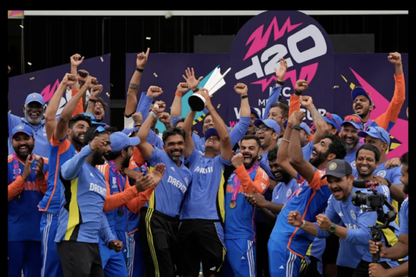 India's head coach Rahul Dravid, center, and Virat Kohli, center right, celebrate with players and team support staff with the winners trophy after defeating South Africa in the ICC Men's T20 World Cup final